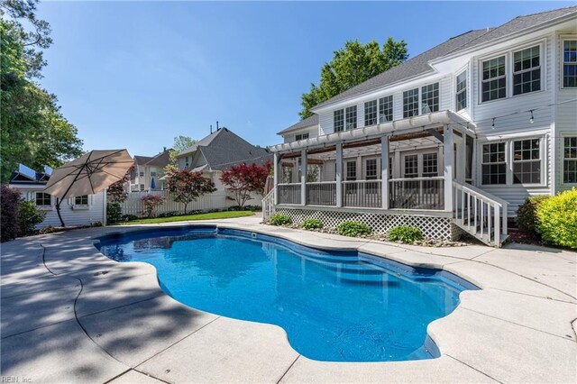 view of swimming pool with a pergola, fence, and a patio