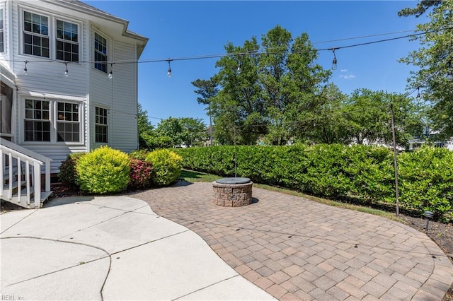 view of patio with an outdoor fire pit