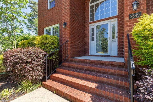 property entrance featuring brick siding