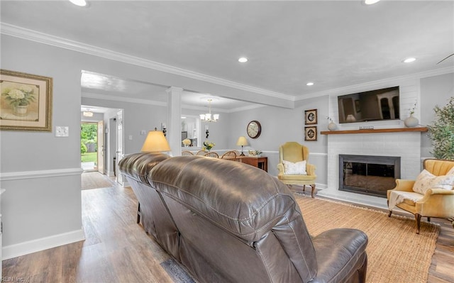 8 Riverview Ct, Suffolk, VA 23434 - living area featuring wood finished floors, a chandelier, a fireplace, recessed lighting, and baseboards
