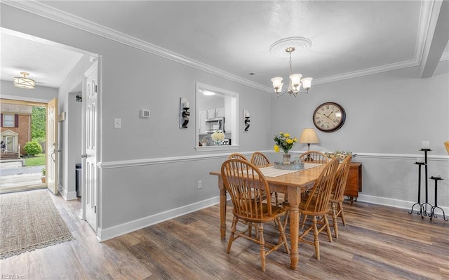 8 Riverview Ct, Suffolk, VA 23434 - dining room featuring wood finished floors, a chandelier, baseboards, and crown molding