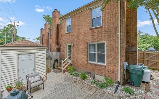 8 Riverview Ct, Suffolk, VA 23434 - back of house featuring brick siding, fence, a wooden deck, entry steps, and an outdoor structure