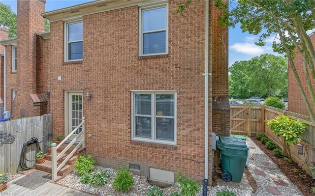 8 Riverview Ct, Suffolk, VA 23434 - back of property featuring entry steps, brick siding, a fenced backyard, a chimney, and crawl space