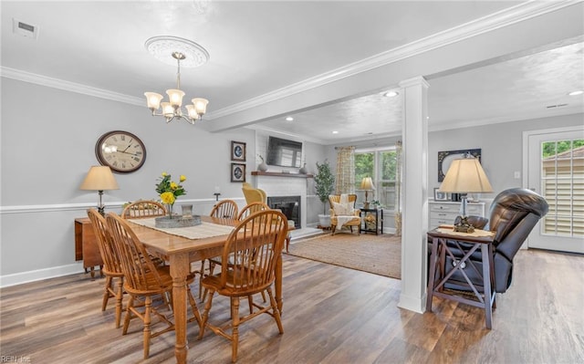 8 Riverview Ct, Suffolk, VA 23434 - dining space featuring healthy amount of natural light, wood finished floors, ornamental molding, a fireplace, and recessed lighting