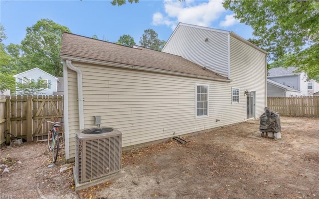 187 N Hunt Club Run, Newport News, VA 23608 - back of property with central AC unit, a fenced backyard, and roof with shingles