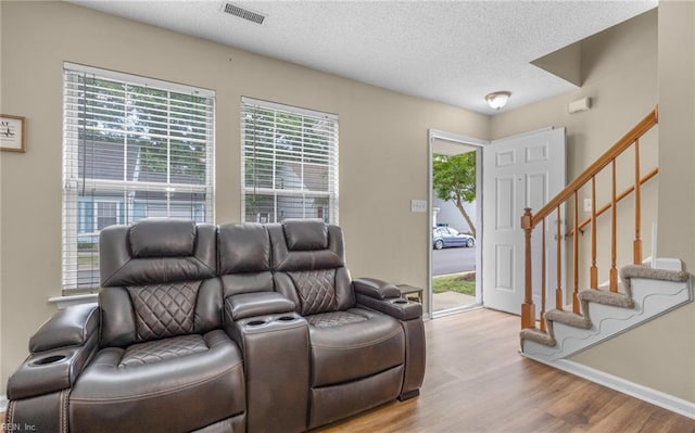 187 N Hunt Club Run, Newport News, VA 23608 - living room featuring wood finished floors, a textured ceiling, stairway, and baseboards