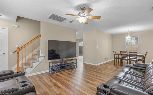 187 N Hunt Club Run, Newport News, VA 23608 - living area featuring wood finished floors, a ceiling fan, a textured ceiling, stairs, and baseboards