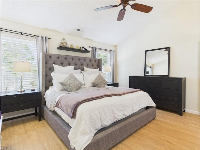 bedroom featuring vaulted ceiling, light wood-style floors, ceiling fan, and baseboards