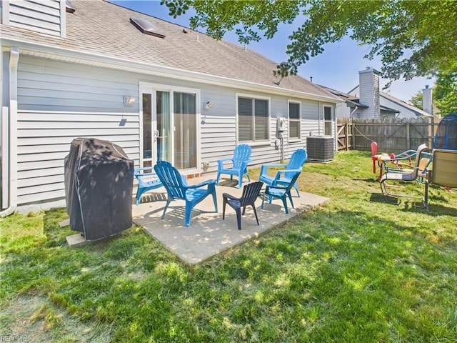 rear view of house with cooling unit, a patio area, and a shingled roof
