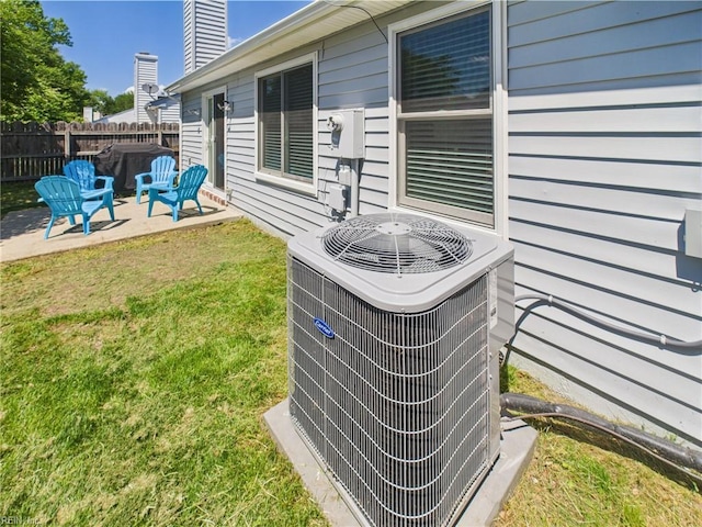 exterior view of central air condition unit, fence, and electric meter