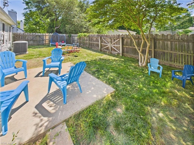 view of yard featuring a patio area and central air condition unit