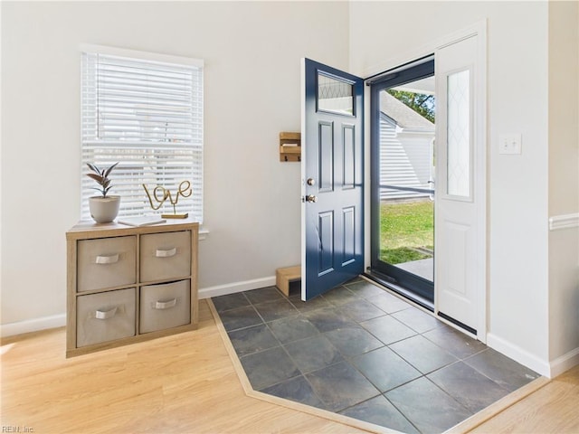 entrance foyer with baseboards and wood finished floors
