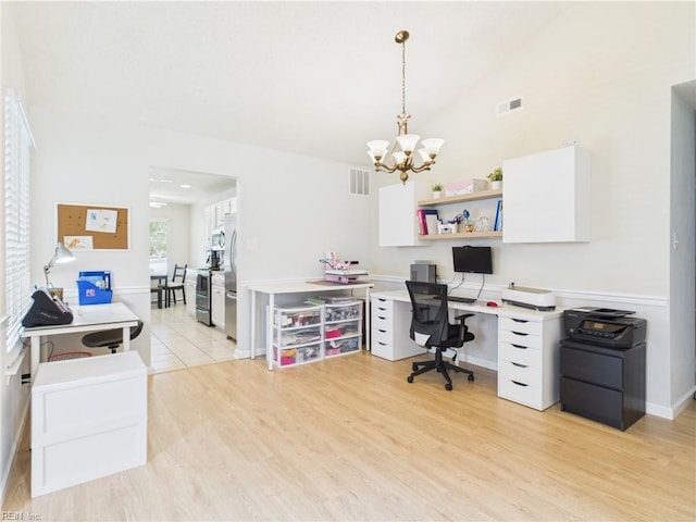 office space featuring a chandelier, light wood-style flooring, vaulted ceiling, and baseboards