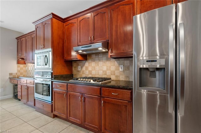 816 Dawson Cir, Chesapeake, VA 23322 - kitchen with stainless steel appliances, under cabinet range hood, dark stone countertops, tasteful backsplash, and light tile patterned floors