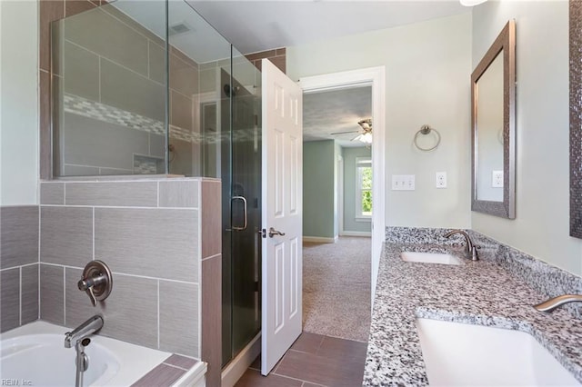 full bath with a shower stall, a bath, ceiling fan, and double vanity