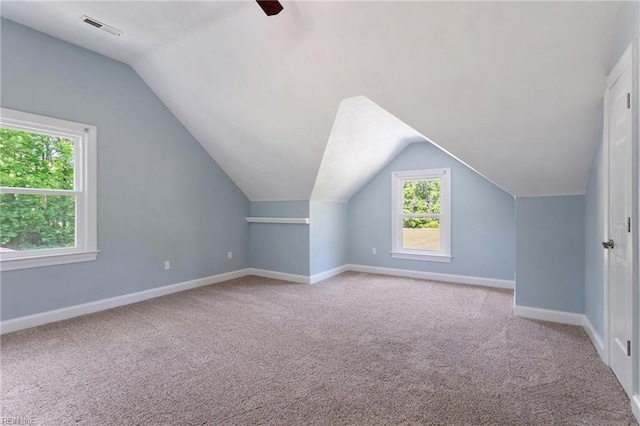 bonus room with carpet, baseboards, vaulted ceiling, and ceiling fan