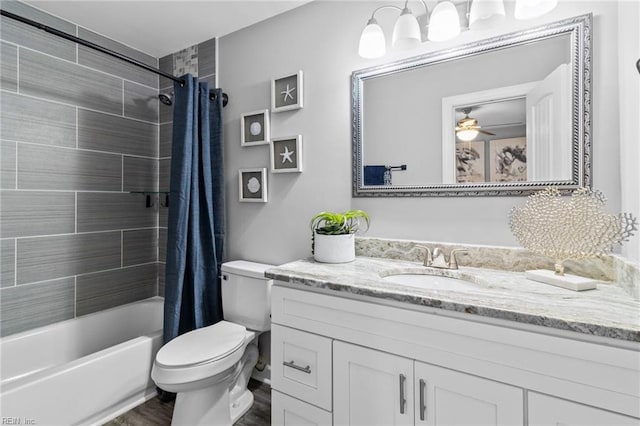 full bathroom featuring toilet, vanity, shower / bath combination with curtain, wood finished floors, and ceiling fan