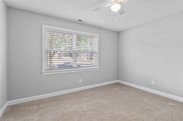 empty room featuring ceiling fan, carpet floors, and baseboards