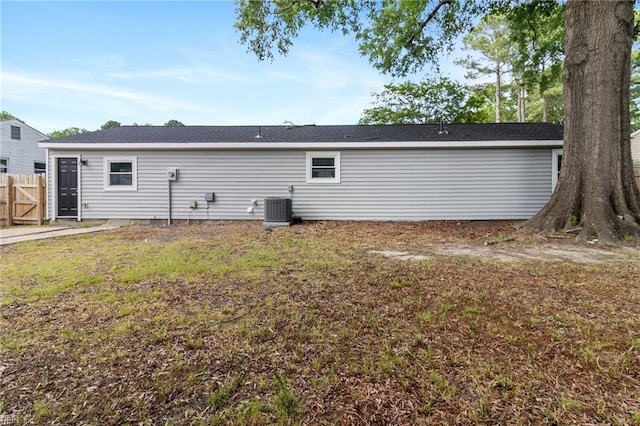 back of house with cooling unit and a gate