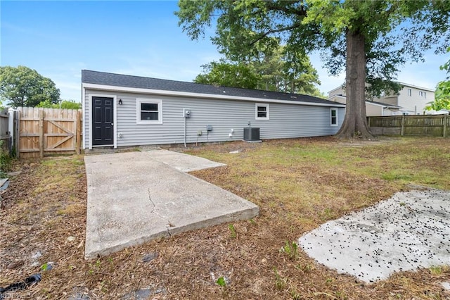 back of house featuring a patio area, cooling unit, and a gate