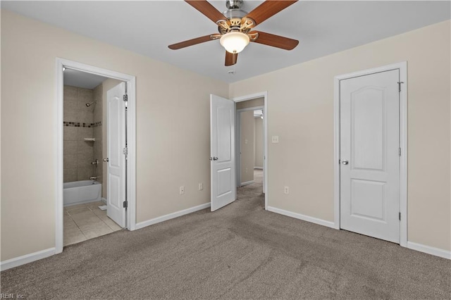 515 Battery Ave, Suffolk, VA 23434 - unfurnished bedroom with carpet, baseboards, tile patterned flooring, a ceiling fan, and connected bathroom