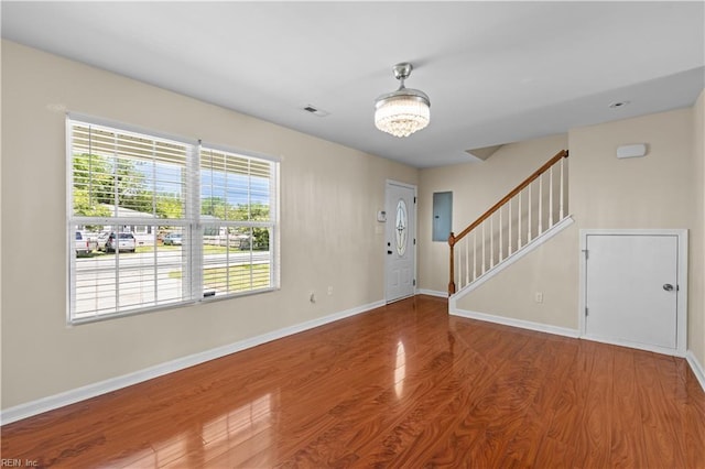 515 Battery Ave, Suffolk, VA 23434 - entrance foyer featuring wood finished floors, baseboards, stairs, electric panel, and a chandelier