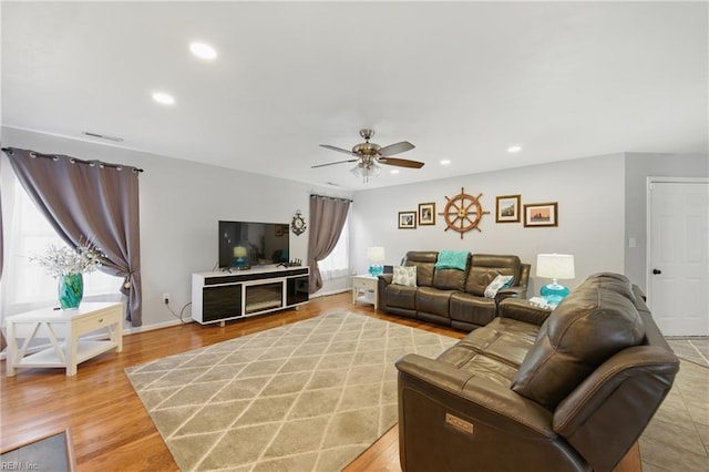 living room featuring ceiling fan, recessed lighting, and light wood-style flooring