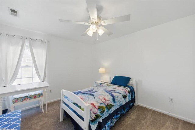 carpeted bedroom featuring baseboards and a ceiling fan