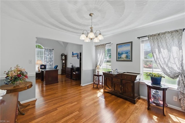 office featuring a chandelier, crown molding, light wood-style flooring, and baseboards