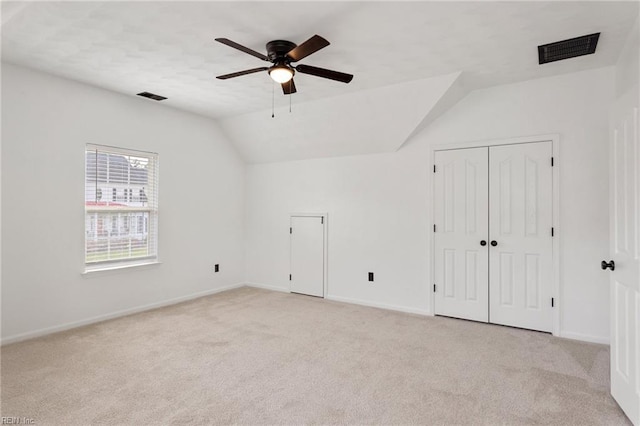 additional living space featuring a ceiling fan, light carpet, baseboards, and vaulted ceiling