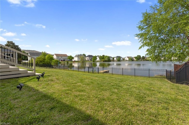 view of yard featuring a water view and a residential view