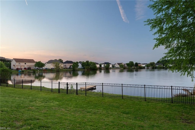 water view featuring fence and nearby suburban area