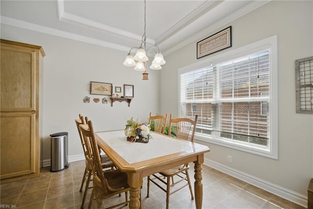 tiled dining area featuring ornamental molding, a raised ceiling, a chandelier, and baseboards