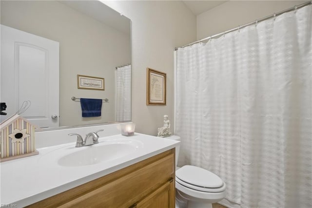 bathroom featuring toilet and vanity