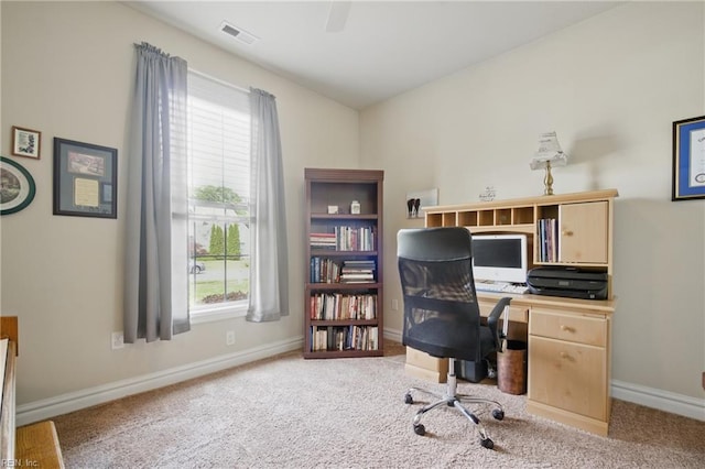 carpeted home office with baseboards