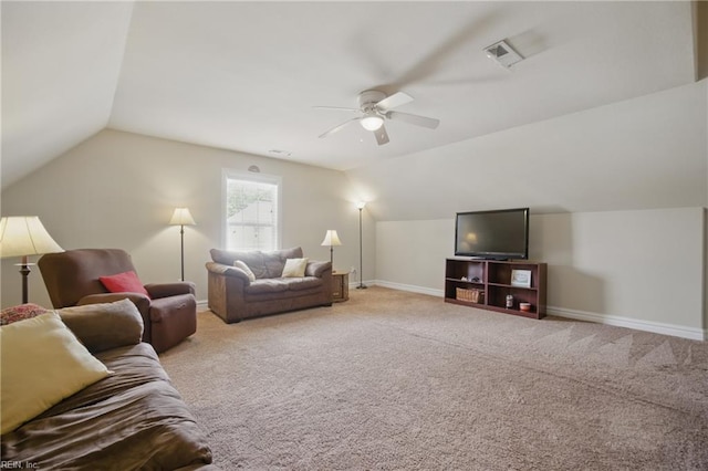 carpeted living area with a ceiling fan, vaulted ceiling, and baseboards