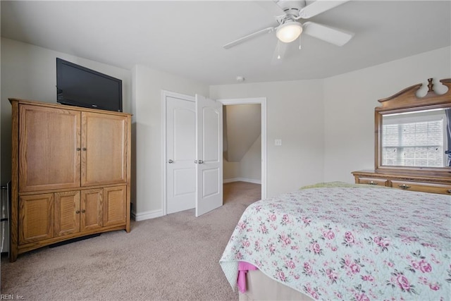 bedroom featuring light colored carpet, ceiling fan, and baseboards