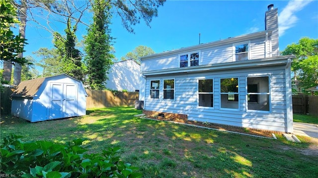 back of property featuring a chimney, a storage unit, an outdoor structure, and central AC
