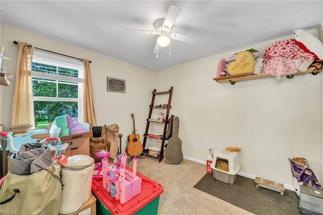 playroom with carpet flooring, ceiling fan, and baseboards