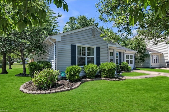 view of home's exterior featuring a yard and driveway