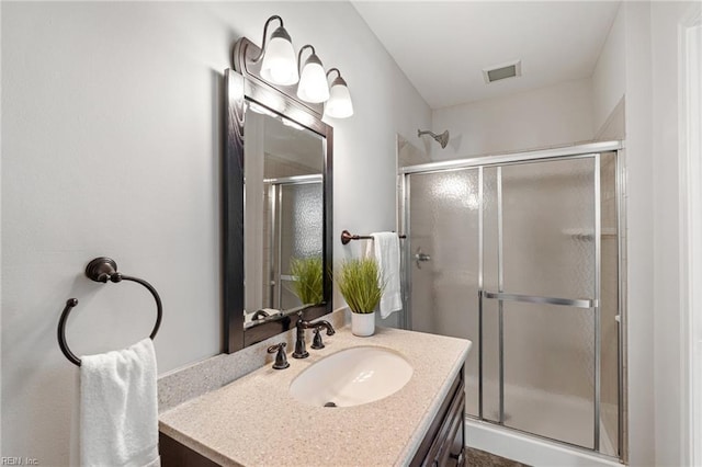 full bath featuring a stall shower and vanity