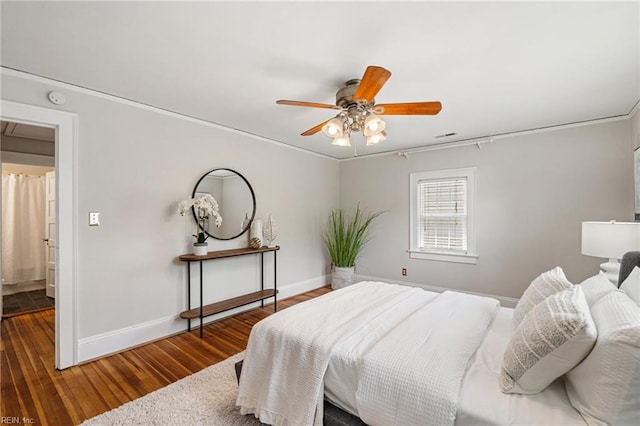 bedroom featuring hardwood / wood-style floors, baseboards, ceiling fan, and crown molding