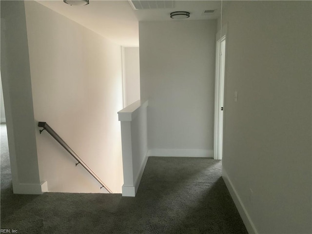 corridor featuring an upstairs landing, carpet floors, and baseboards