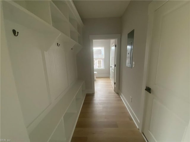 mudroom featuring light wood-style floors and baseboards