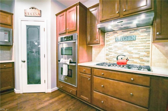 9613 Old Church Rd, New Kent, VA 23124 - kitchen featuring under cabinet range hood, appliances with stainless steel finishes, dark wood finished floors, light countertops, and tasteful backsplash