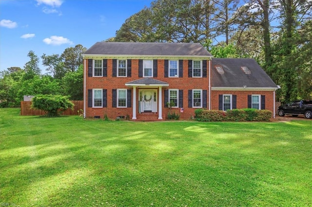 colonial home featuring brick siding