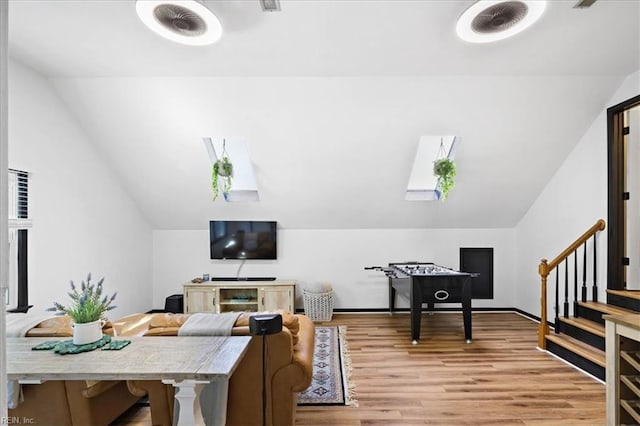 home office featuring lofted ceiling and light wood-style floors