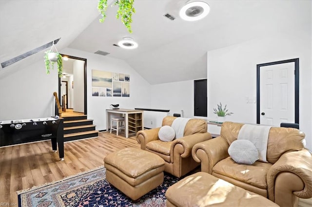 living room featuring wood finished floors and vaulted ceiling