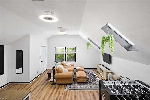 living room with lofted ceiling and light wood-style floors