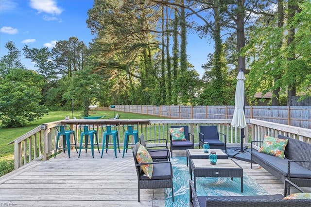 deck featuring outdoor lounge area and view of scattered trees